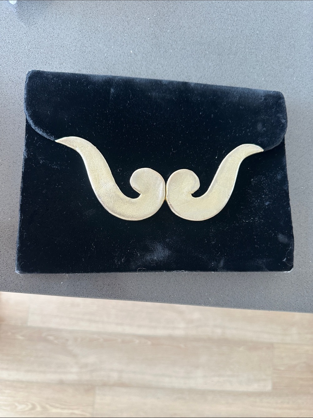Yves Saint Laurent Black Velvet Clutch with Gold Sculptural Emblem